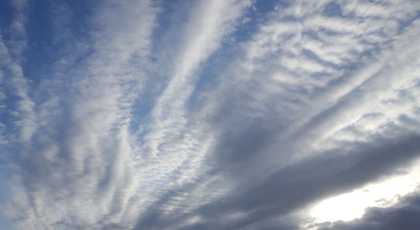 Rays of cloud and light near sunset, blue and white