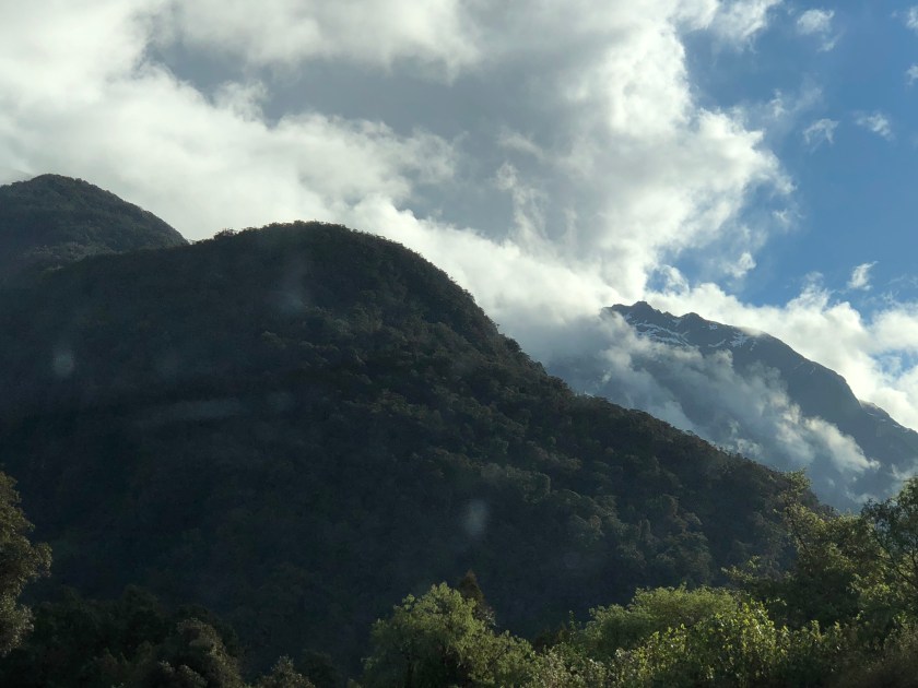 NZ, mountains w trees, snow layers, clouds