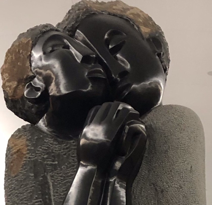 Two bronze people embracing, Atlanta airport