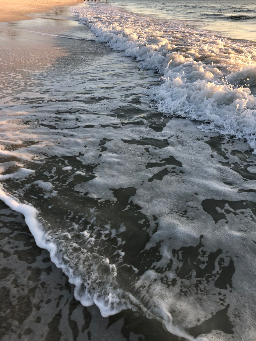 Waves w foam in light, vertical